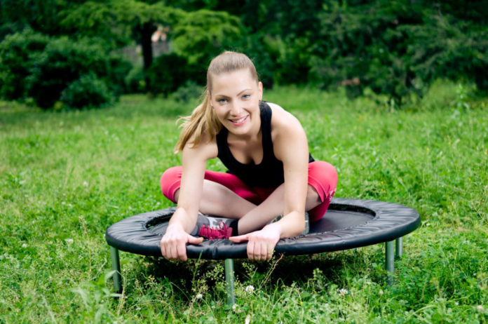Woman working out with a fitness trampoline