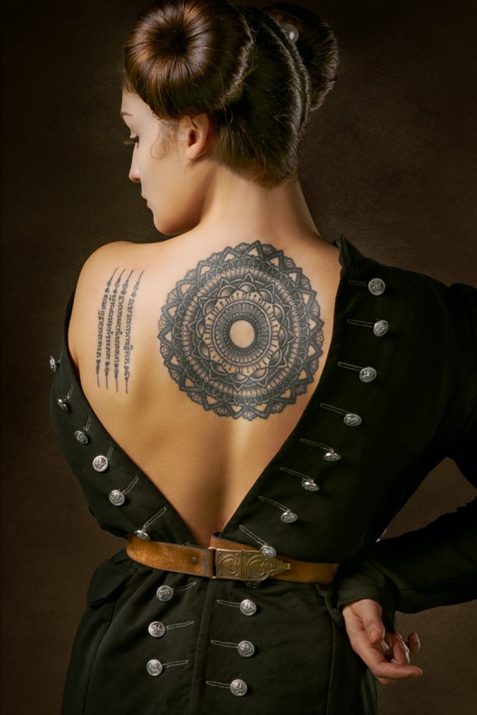 Woman with back tattoos